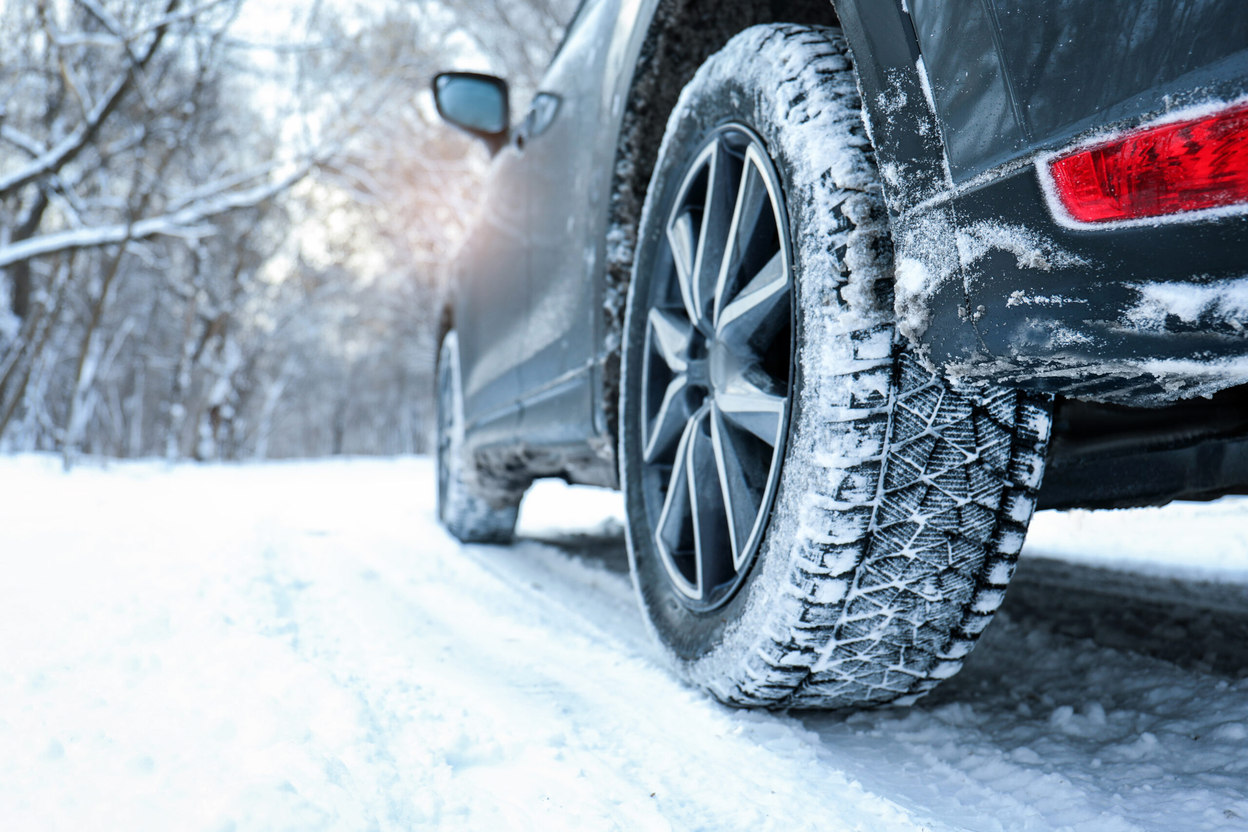 Snowy country road with car on winter day, closeup. Space for te Snowy country road with car on winter day, closeup. Space for text